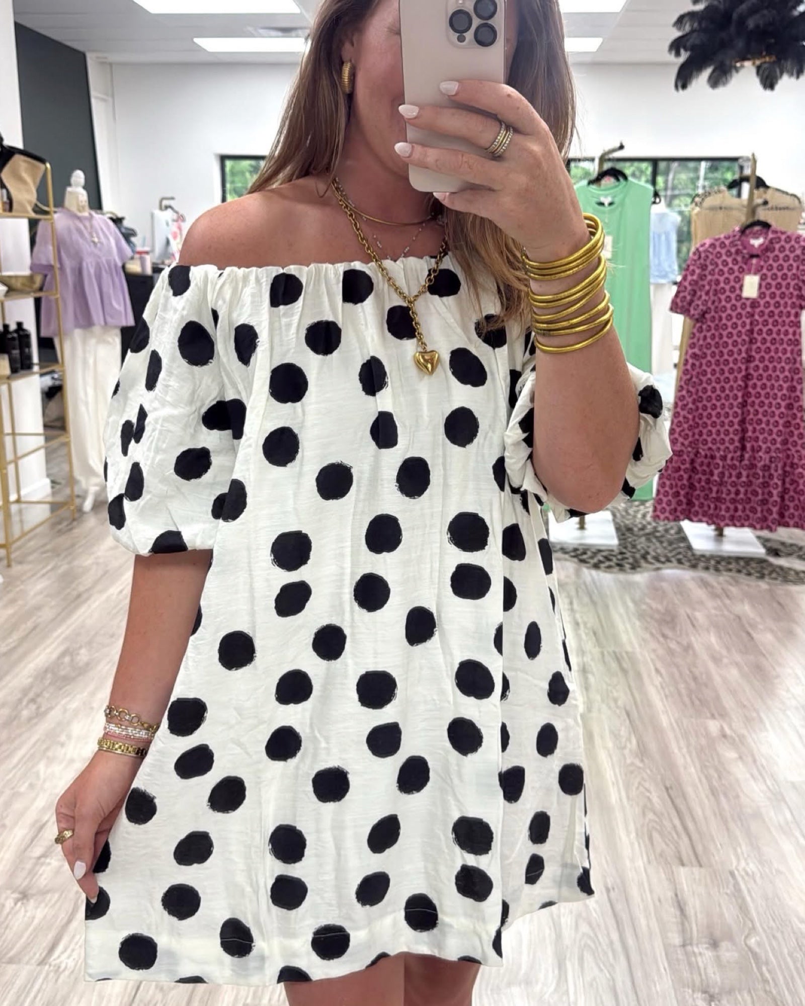 Woman wearing a polka dot dress in a store setting