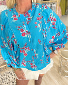 electric blue floral blouse boutique front view